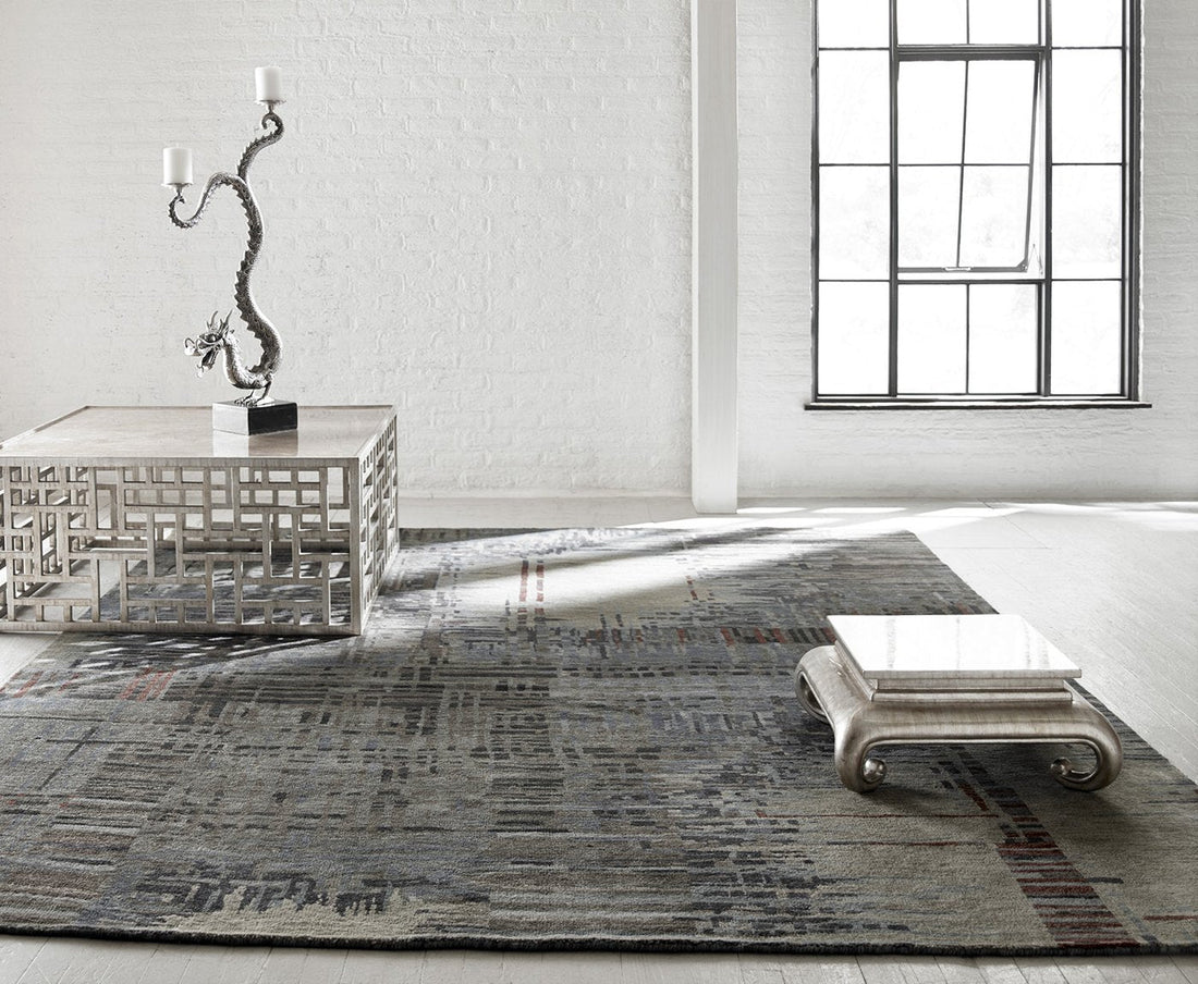 Cream and grey modern area rug sized correctly for a bright living room