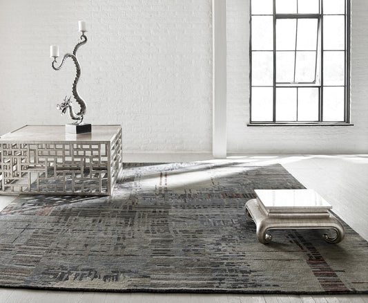 Cream and grey modern area rug sized correctly for a bright living room