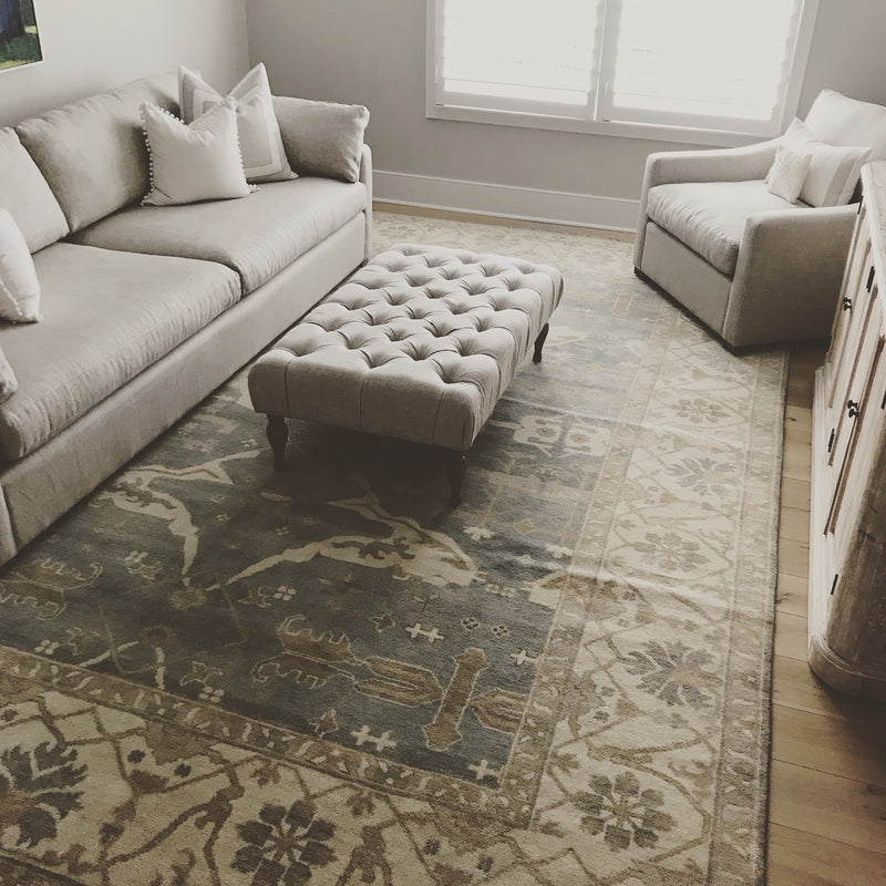 Living room seating area with blue-gray Oushak style rug
