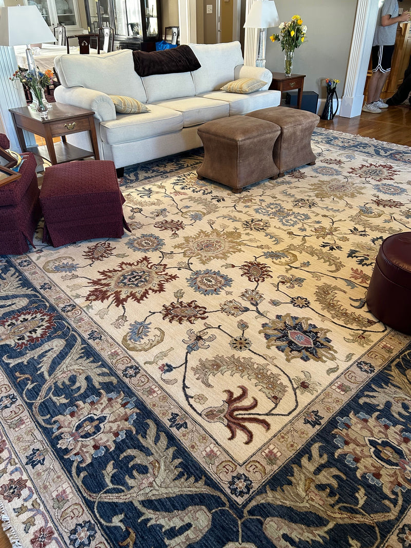 Living room with cream and navy floral area rug